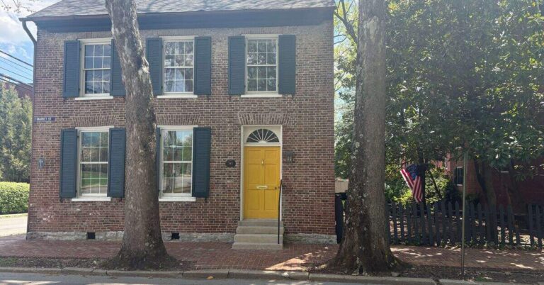 Historic Federal-style brick home with yellow door on Market Street in Lexington Kentucky