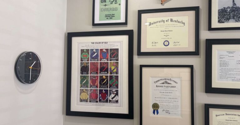 Buckles Law Office wall displaying Kentucky Colonel commission University of Kentucky diploma and local Lexington art